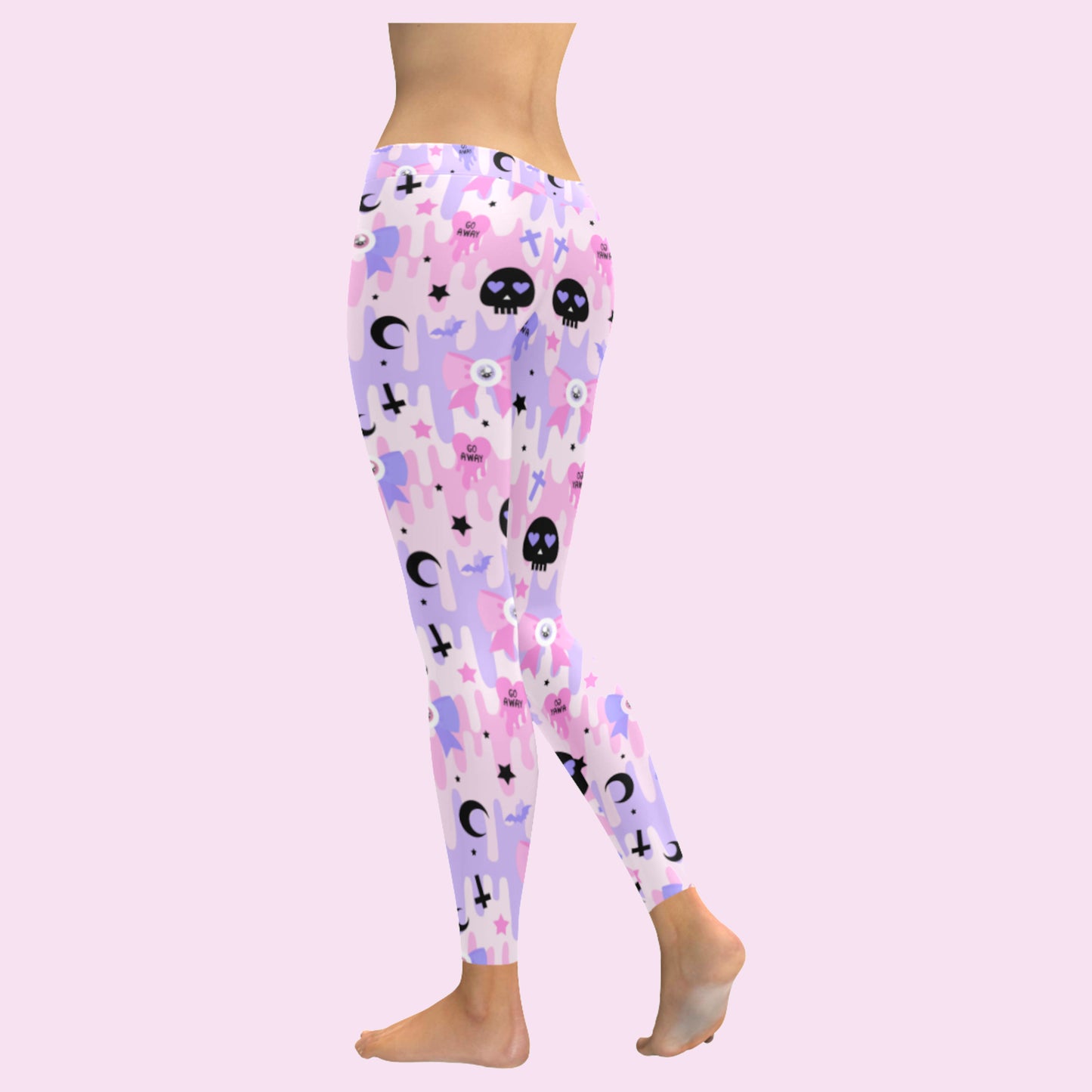 pink pastel goth skull leggings displayed on a pink background.