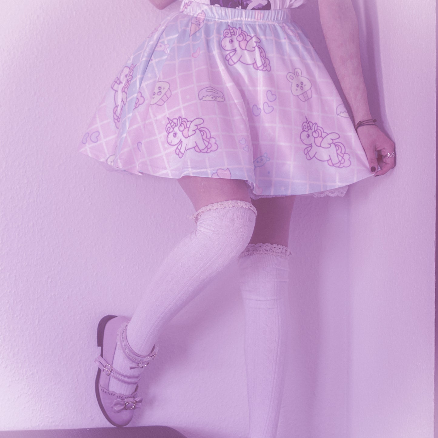 Happy girl dressed in a fairy kei unicorn pastel skirt