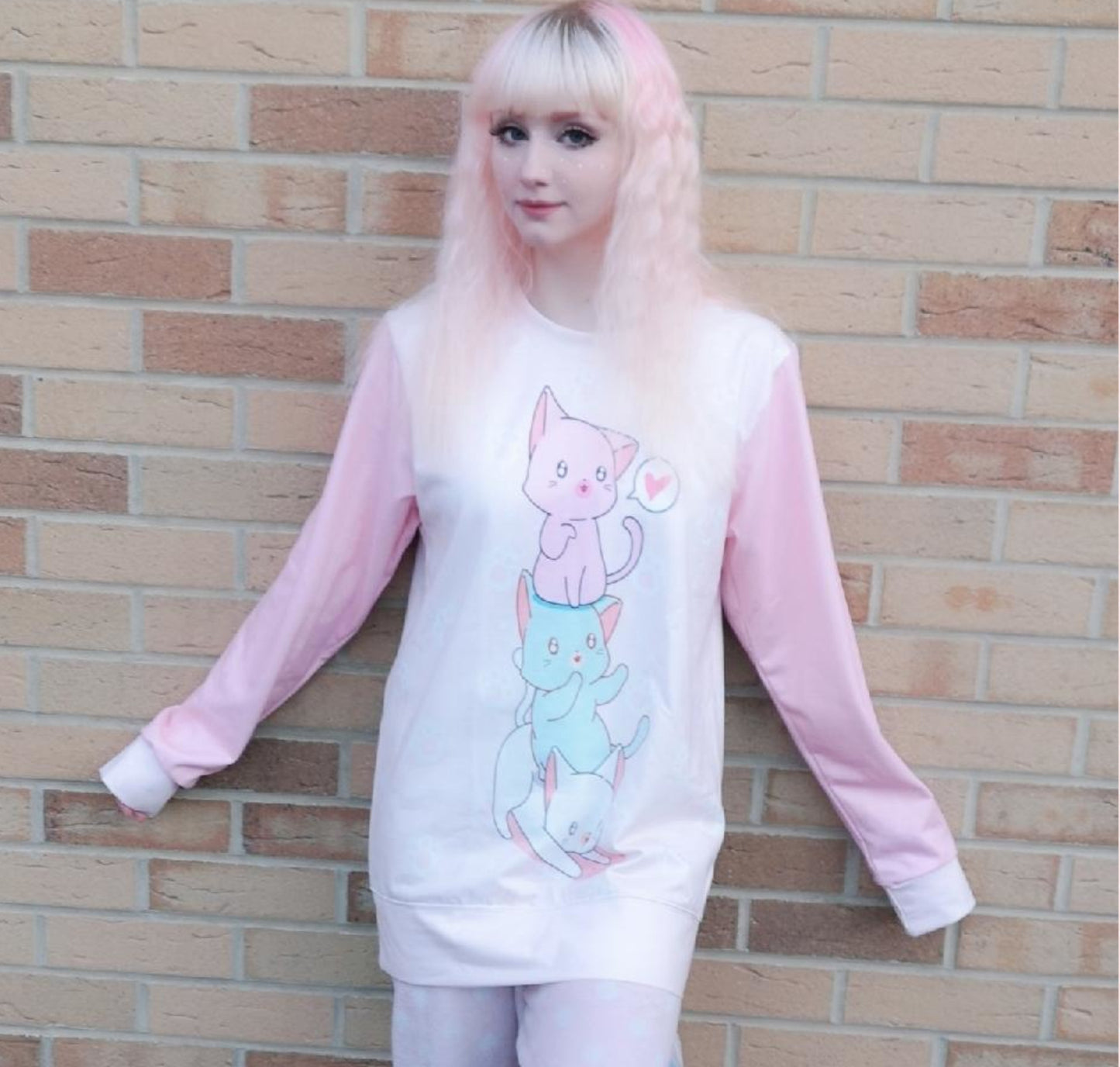 Young girl wearing a pastel kawaii sweatshirt with a cute print, smiling