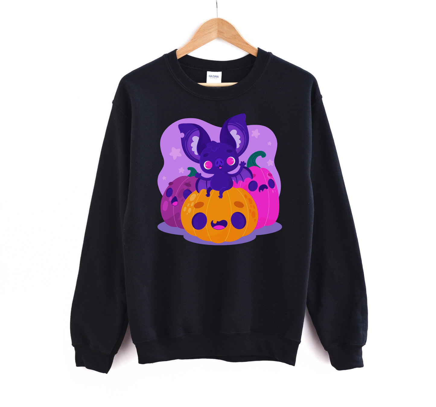 Black sweatshirt with Halloween-themed design featuring a purple bat and orange pumpkin on a white background.