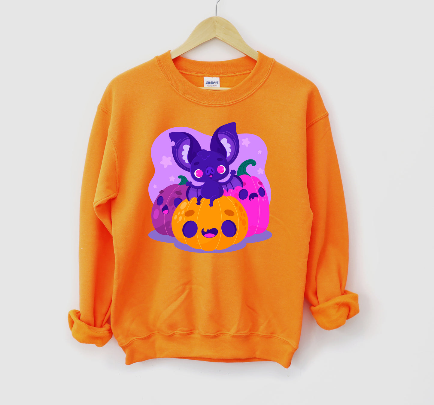 Kawaii sweatshirt with Halloween-themed graphics and bat on a white background.