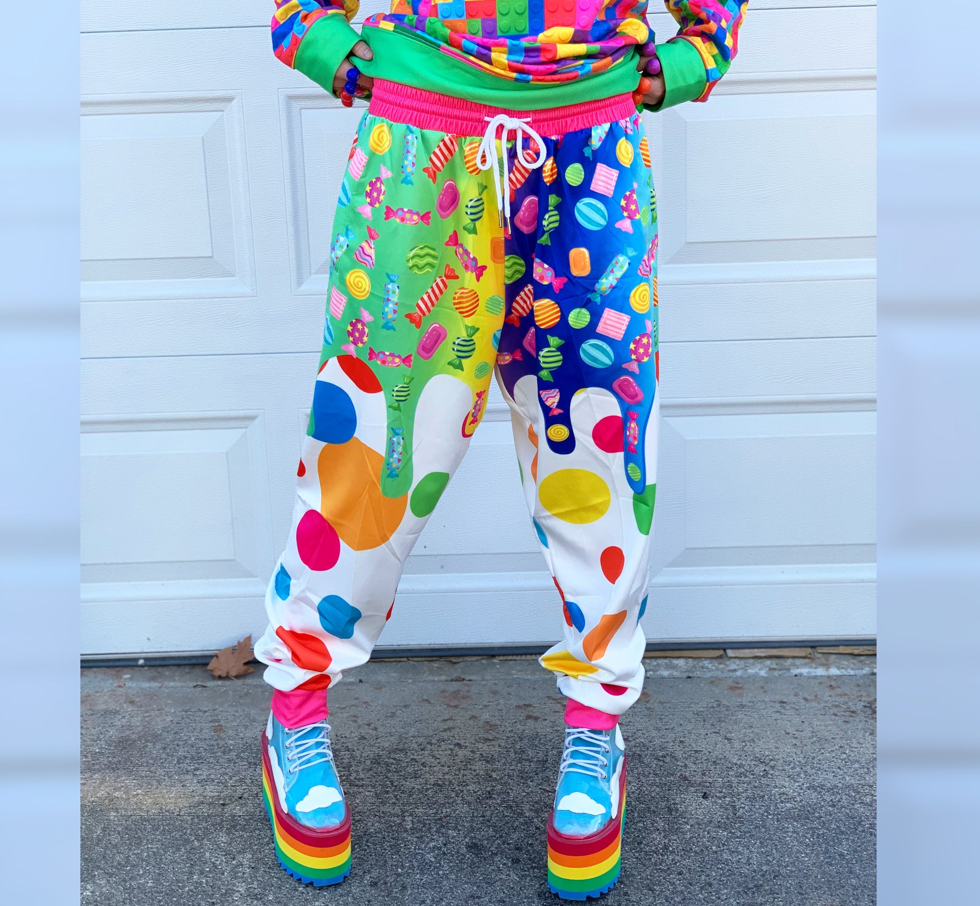 Young boy wearing Kidcore Rainbowcore Harajuku jogger pants with candy print