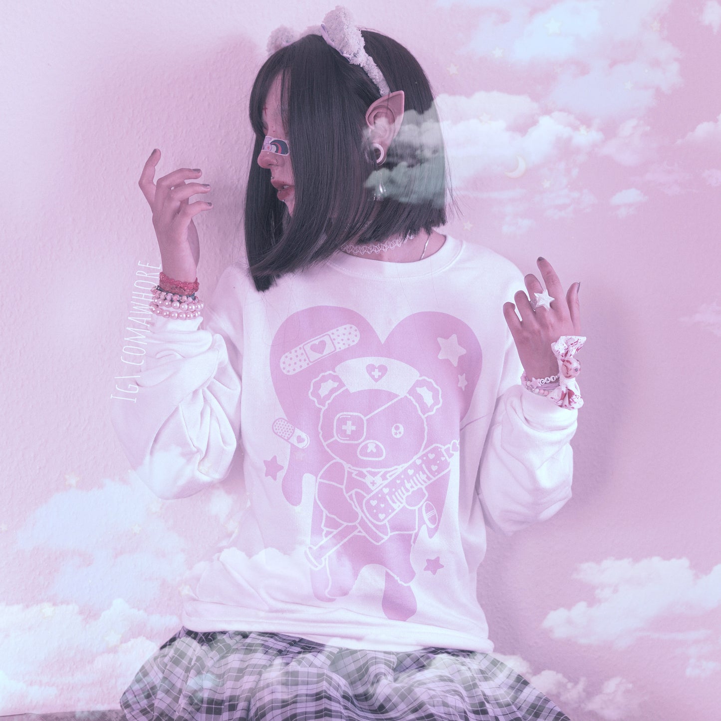 Cute girl modeling a Menhera kawaii aesthetic sweatshirt displayed on a pink background