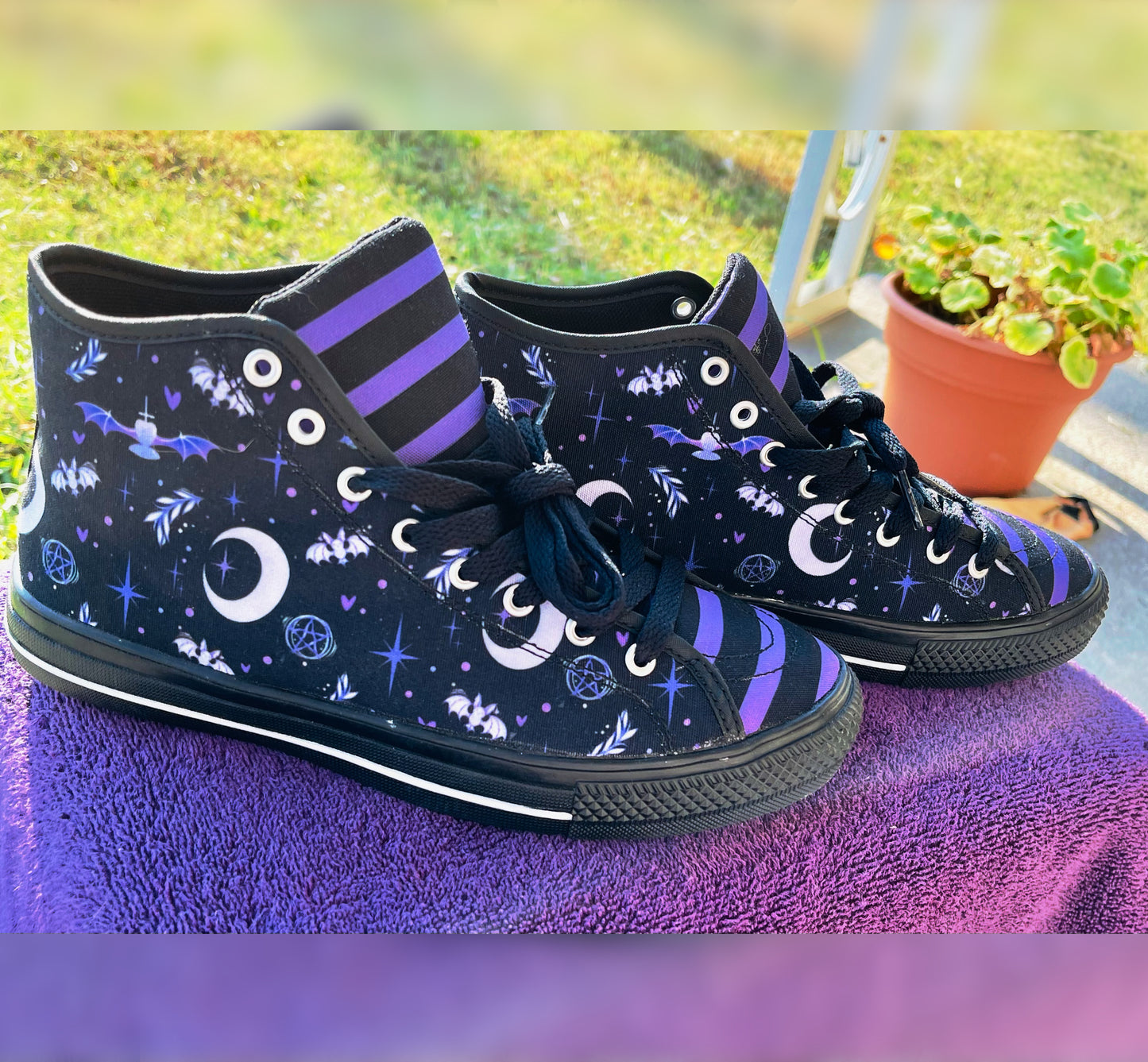Pair of cute, stylish shoes neatly arranged on a purple background