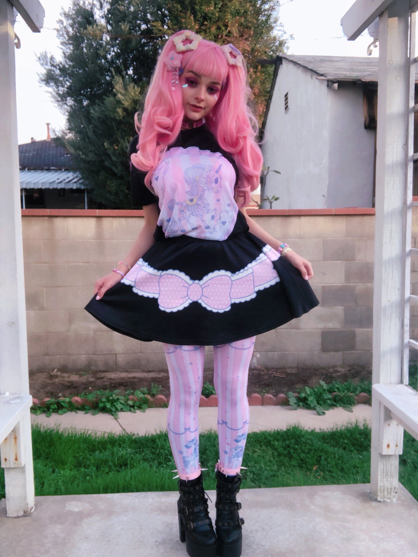 Youth model wearing a kawaii pastel goth unicorn skeleton t-shirt and matching skirt