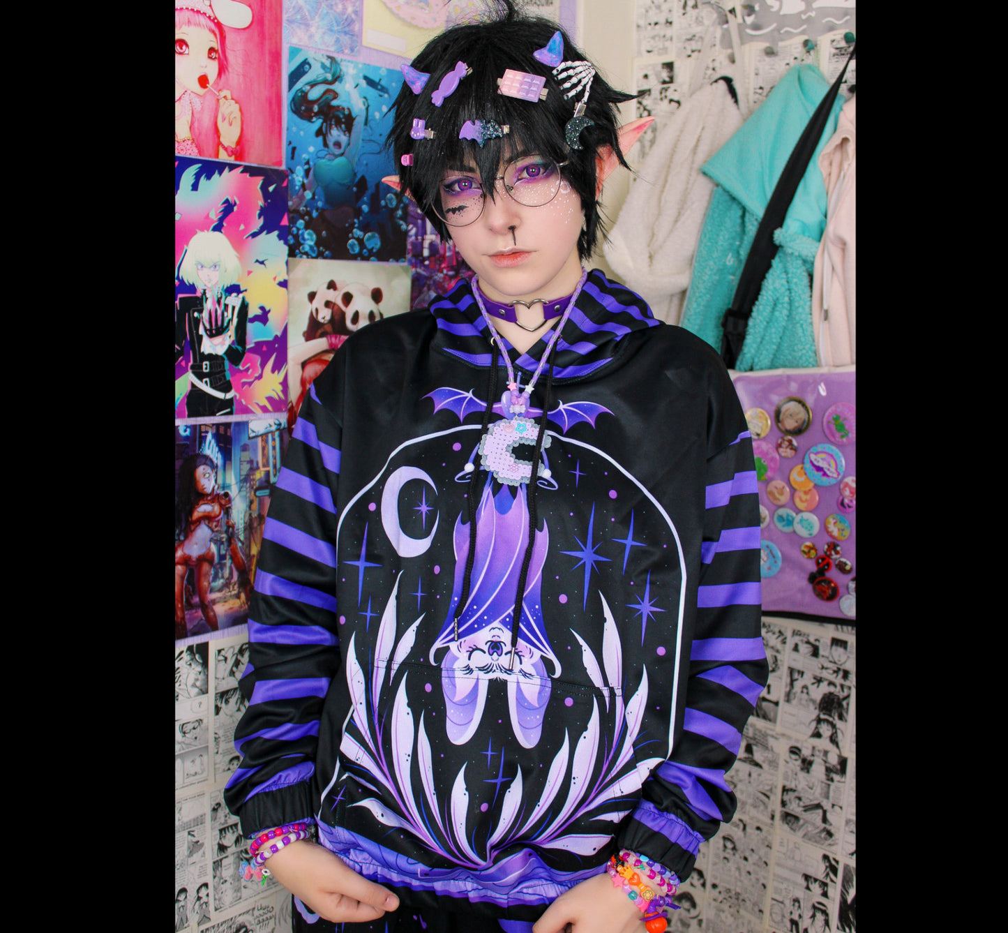 Young boy wearing a pastel goth hoodie sweatshirt with creepy bat design