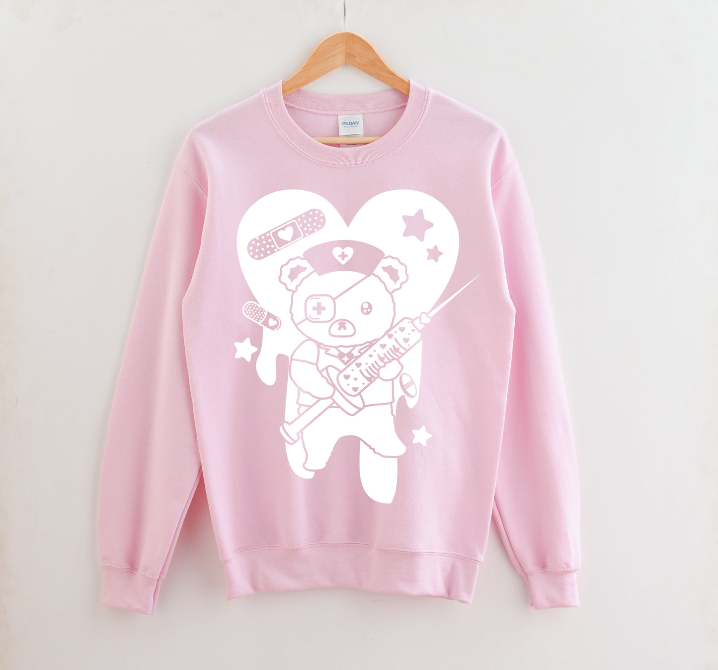 Pink Menhera Kei Bear Band Aid kawaii aesthetic sweatshirt displayed on clean background.
