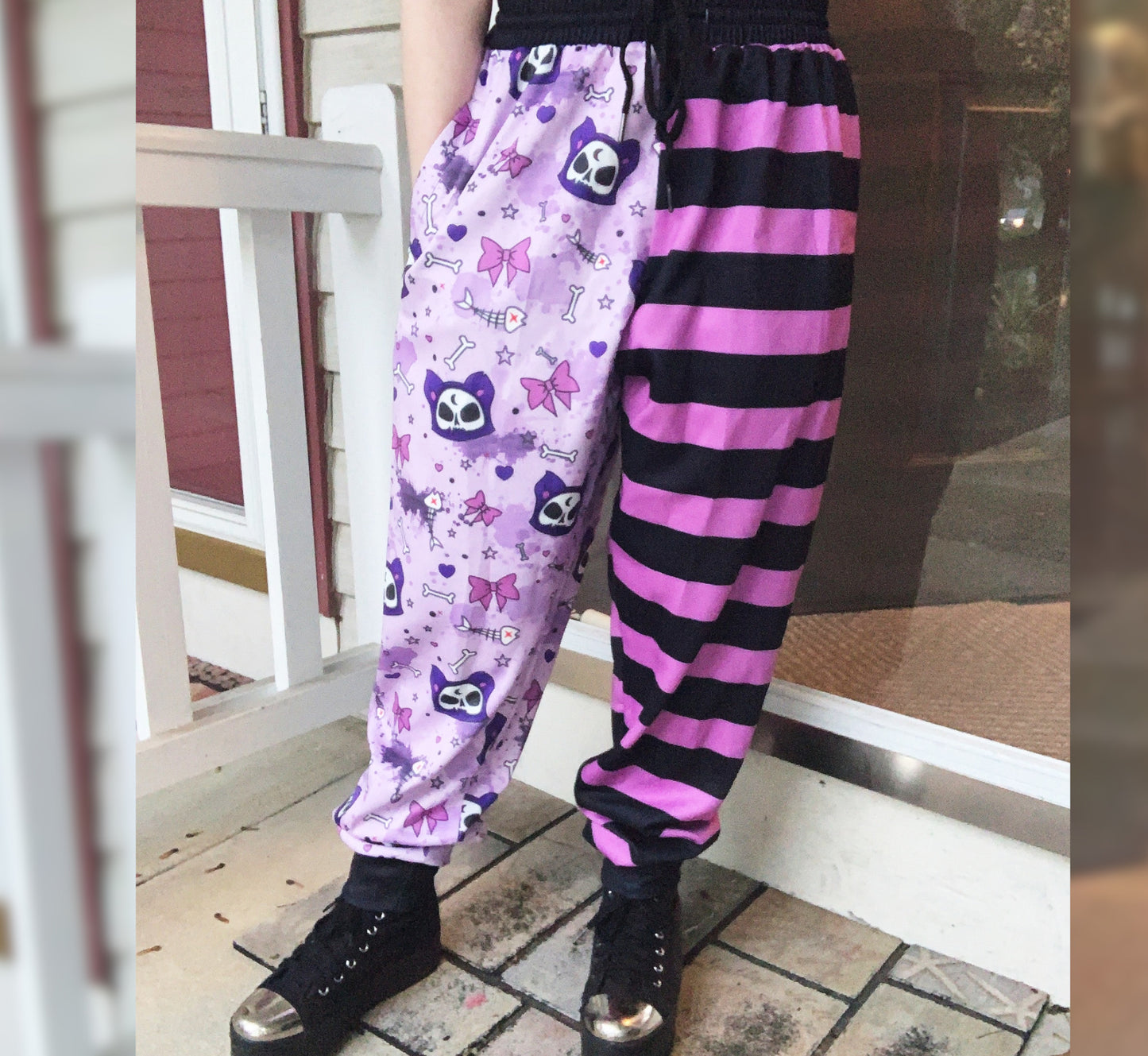 Youth model wearing a kawaii pastel goth cat joggers