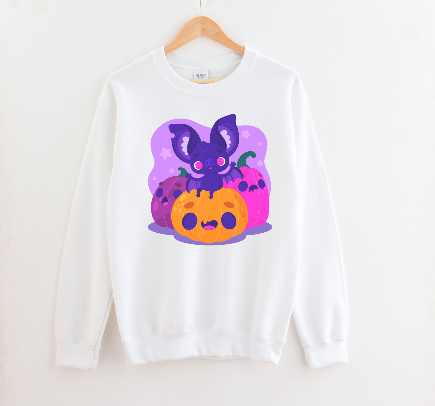 Kawaii sweatshirt with Halloween-themed graphics and bat on a white background.