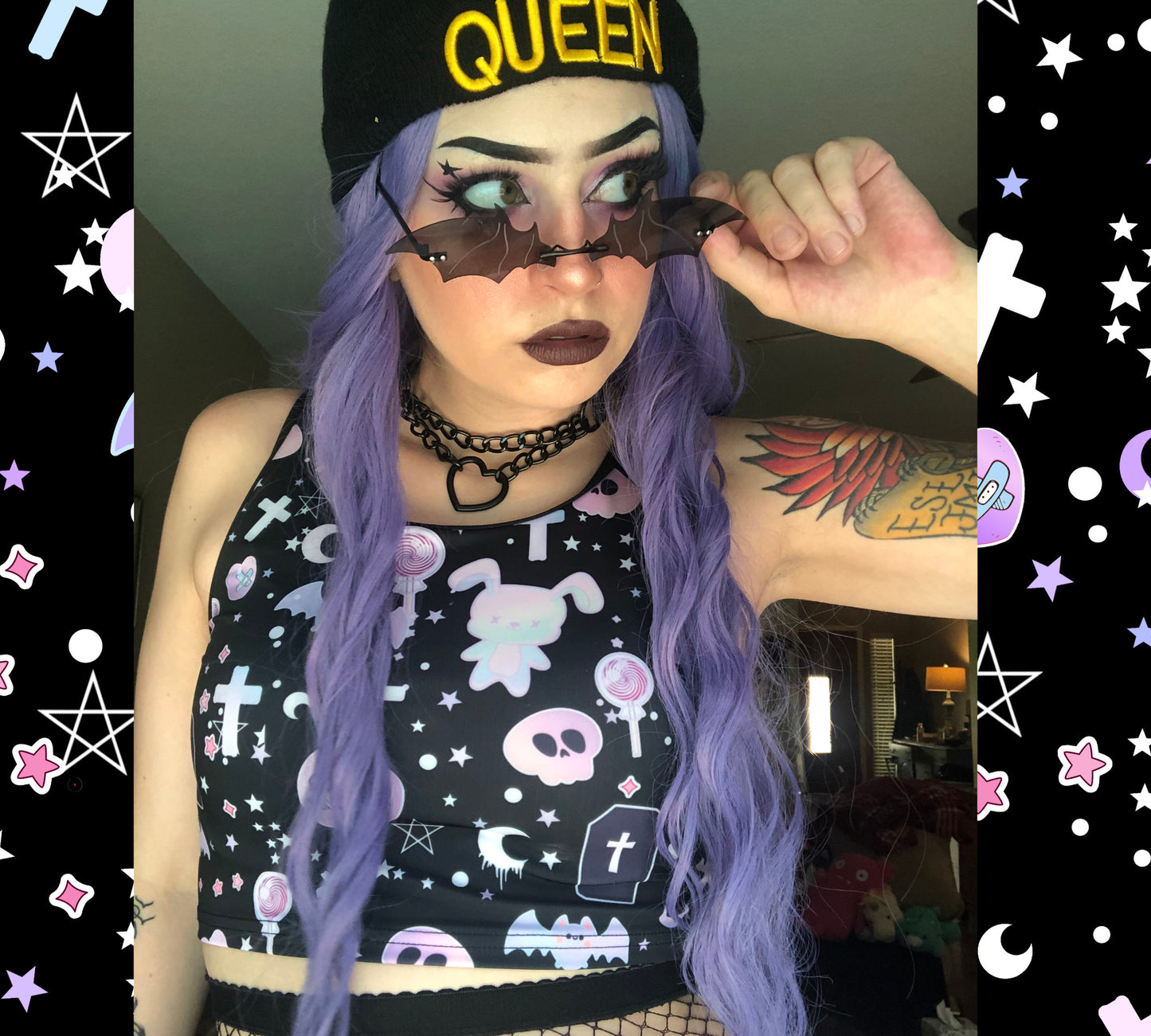 Teen girl dressed in pastel goth fashion with a spooky-cute graphic crop top