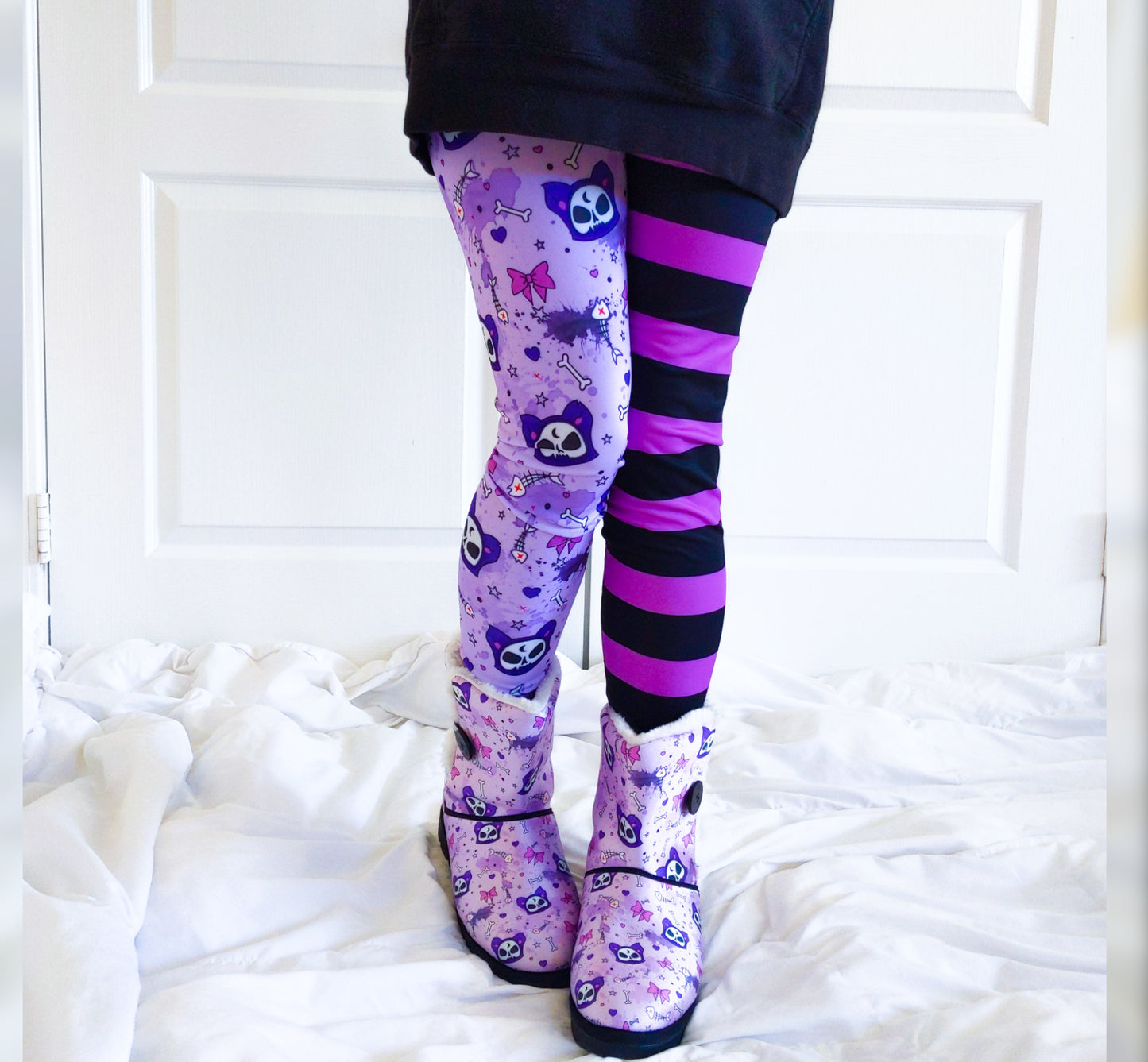 Teen girl dressed in pastel goth fashion with a spooky-cute leggings.