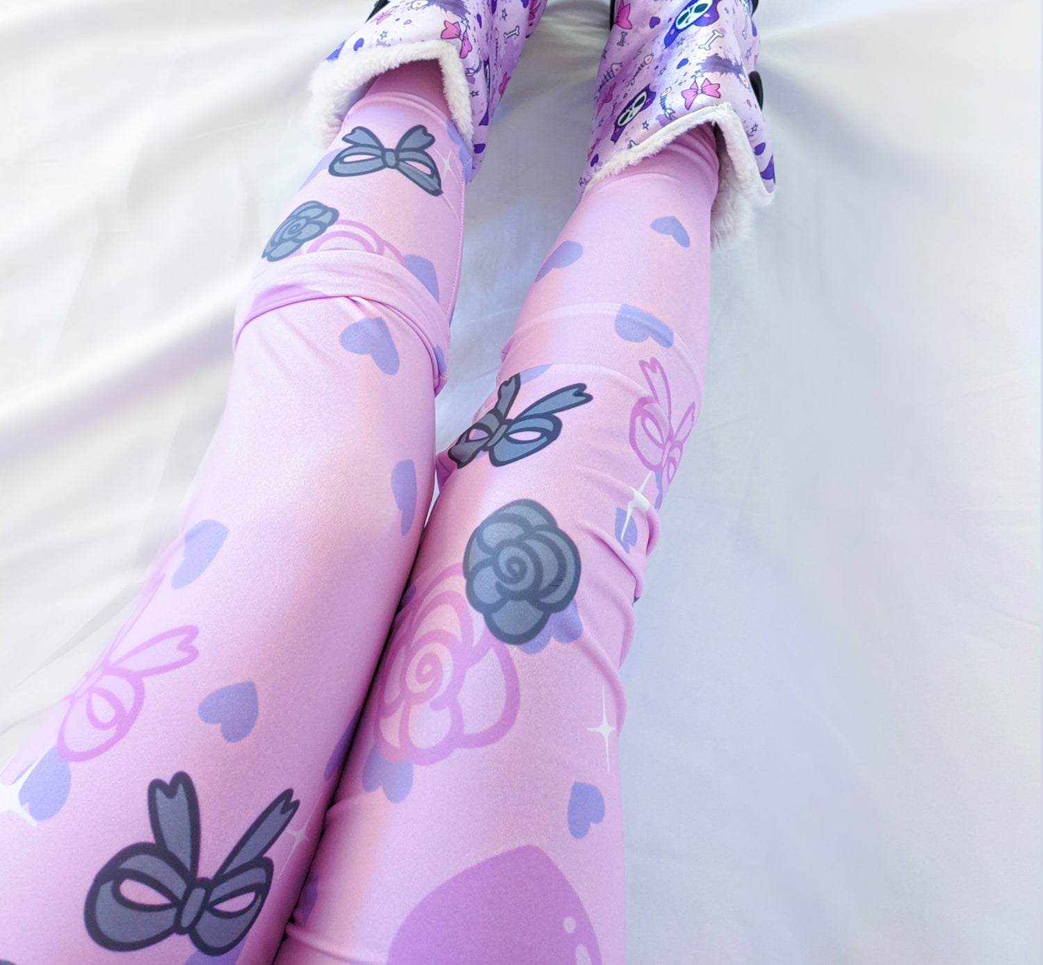 Model wearing pastel  yume kawaii pink leggings with a cute print