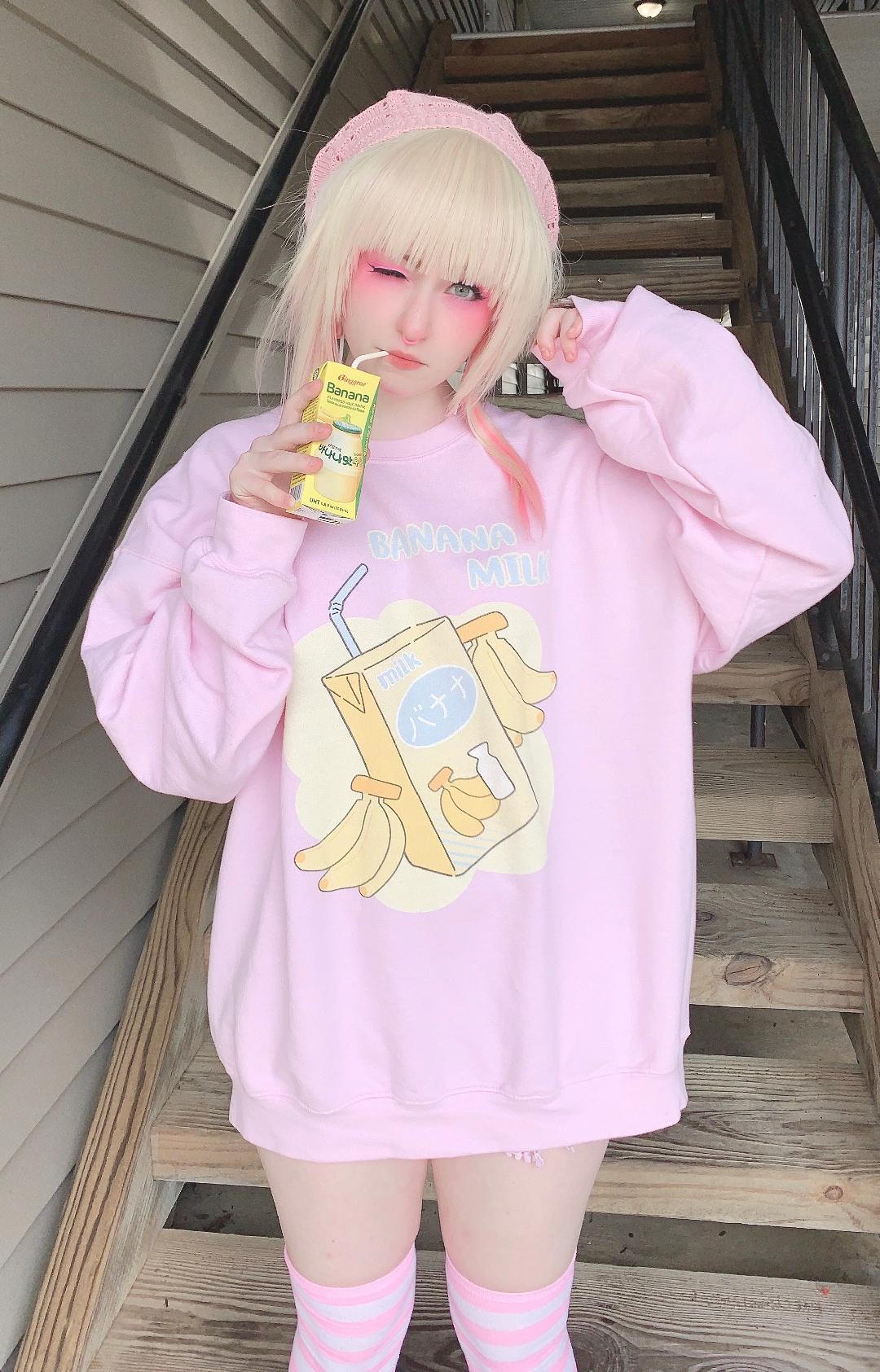 Youthful model wearing a cute kawaii sweatshirt with pastel accessories