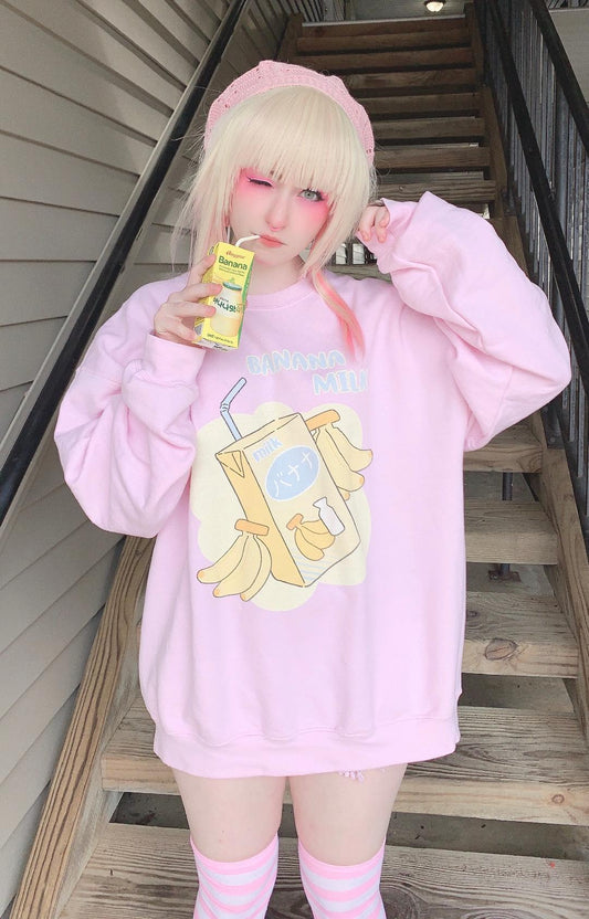 Youthful model wearing a cute kawaii sweatshirt with pastel accessories