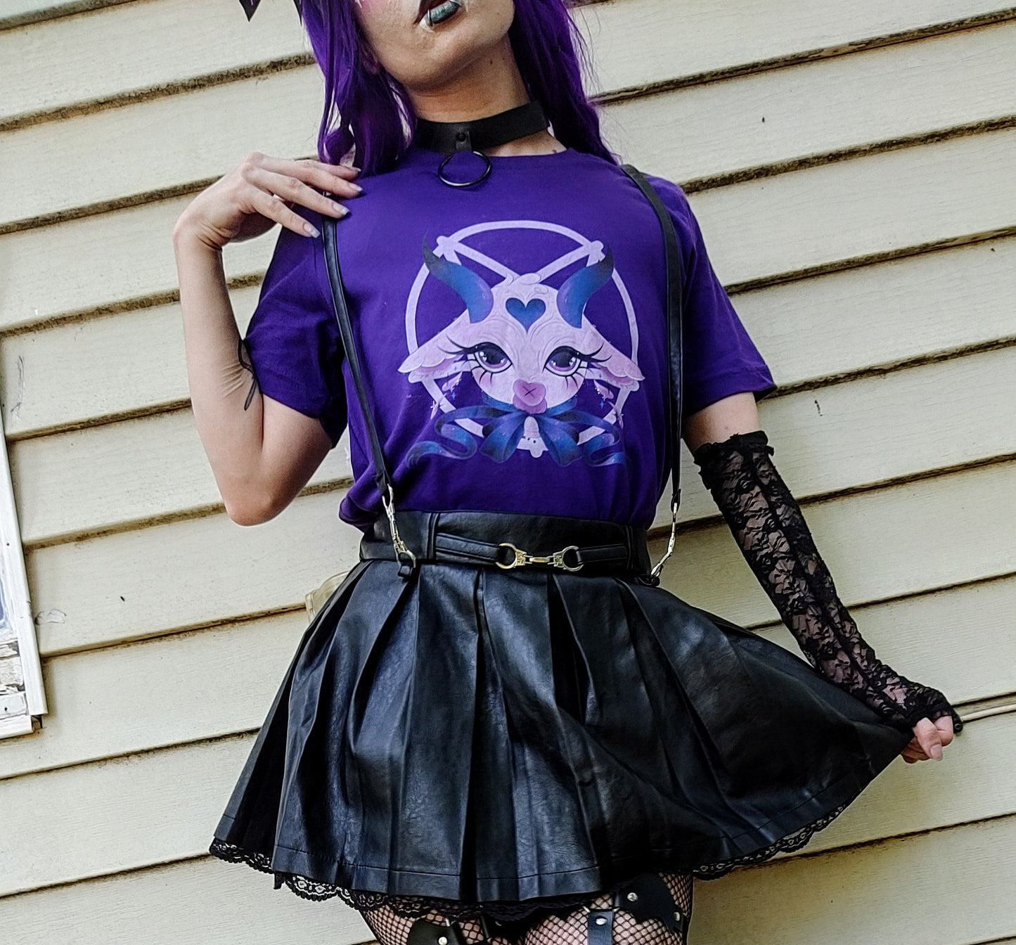 Teen girl dressed in pastel goth fashion with a spooky-cute graphic tee