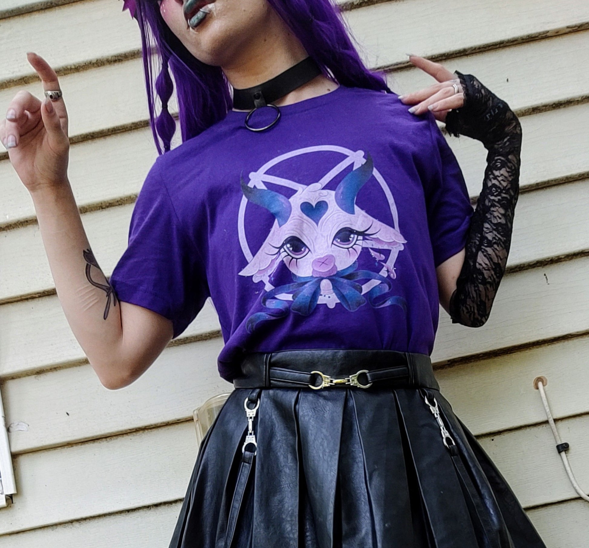Teen girl dressed in pastel goth fashion with a spooky-cute graphic tee