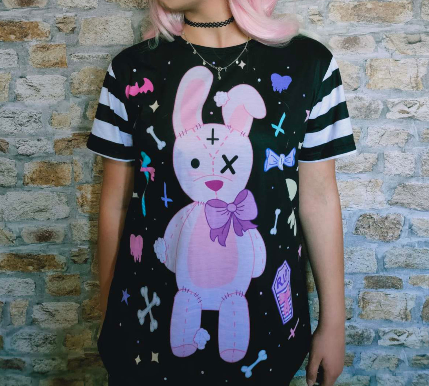 Teen girl dressed in kawaii goth fashion with a spooky-cute graphic t-shirt