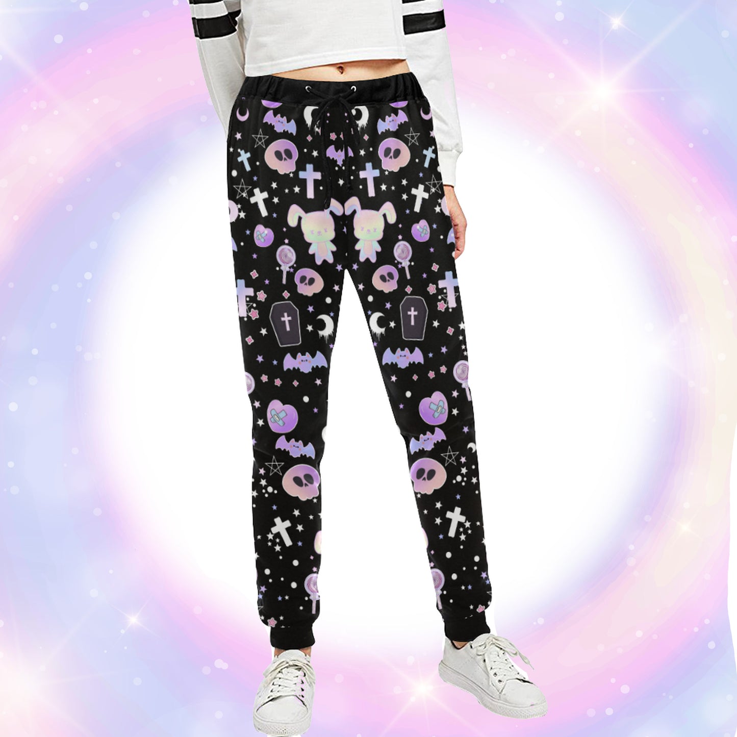 Model wearing a pastel goth joggers with black and purple colours and creepy cute bats and skulls design on pastel background