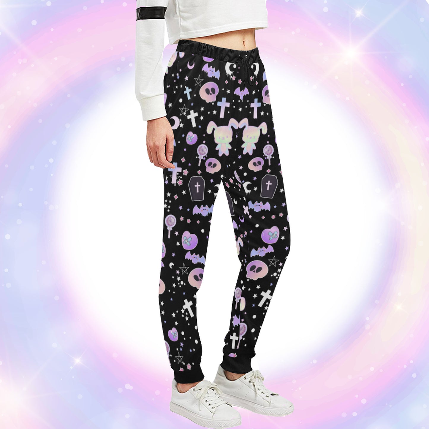 Model wearing a pastel goth joggers with black and purple colours and creepy cute bats and skulls design on pastel background