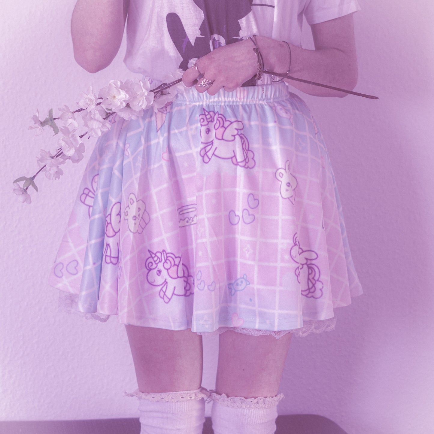 Happy girl dressed in a fairy kei unicorn pastel skirt