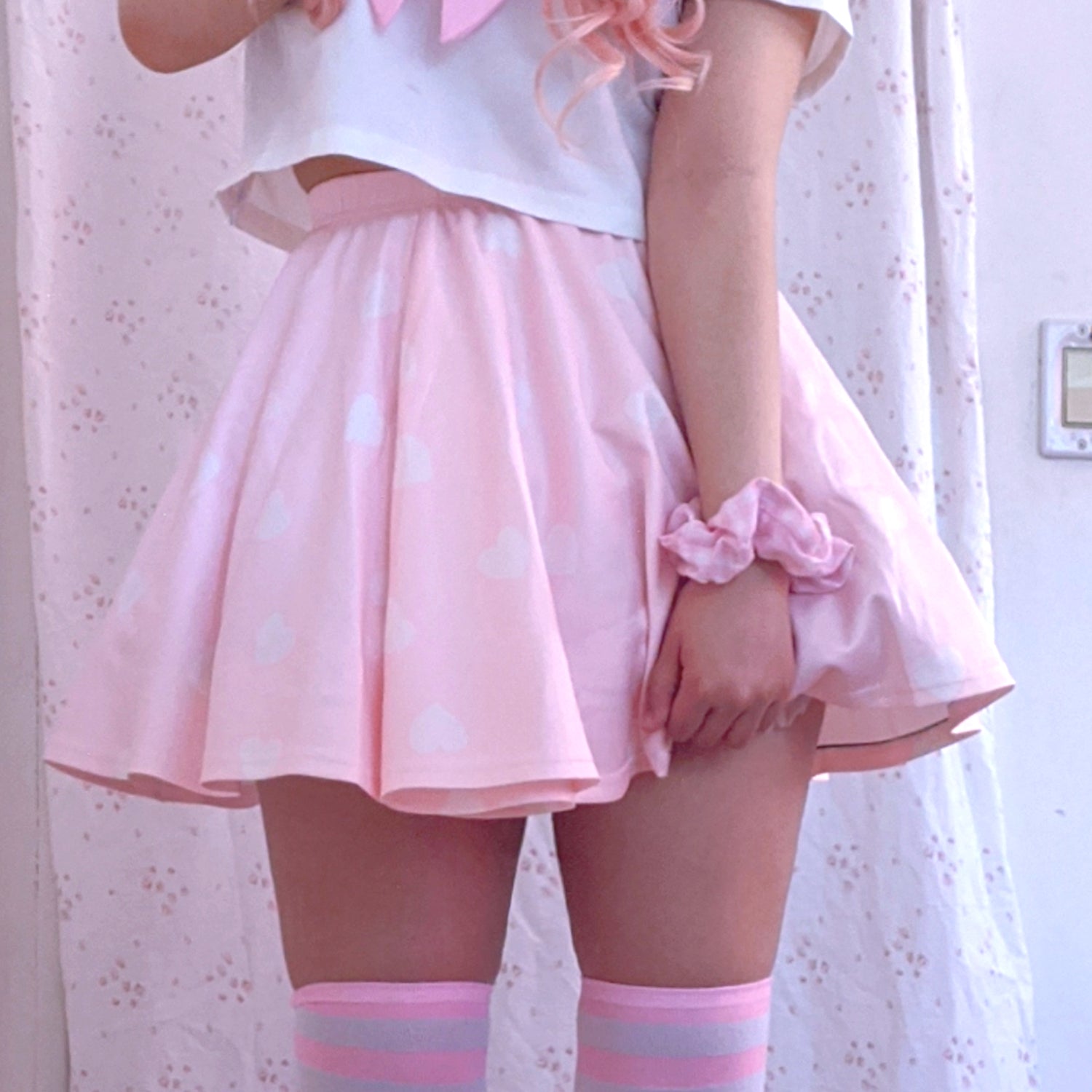 Youthful model wearing a cute kawaii skirt with pastel accessories