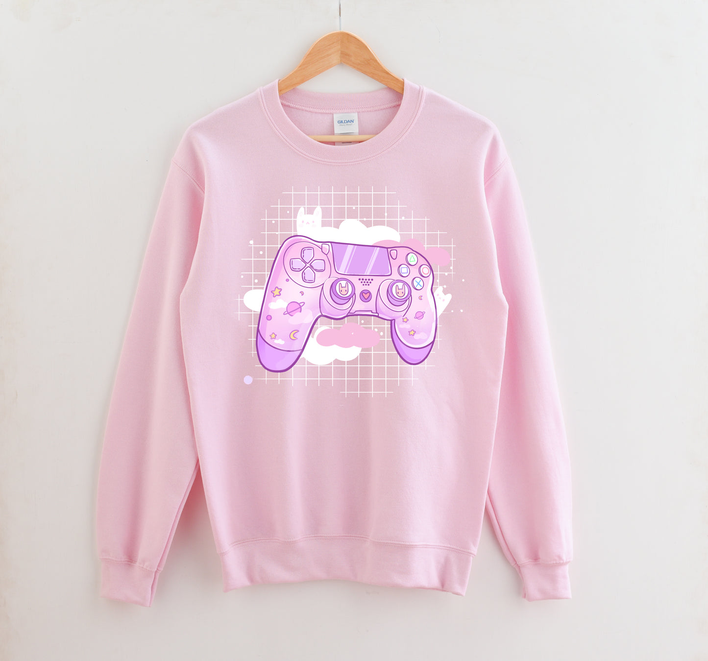 Pink pastel kawaii sweatshirt displayed on clean white background.
