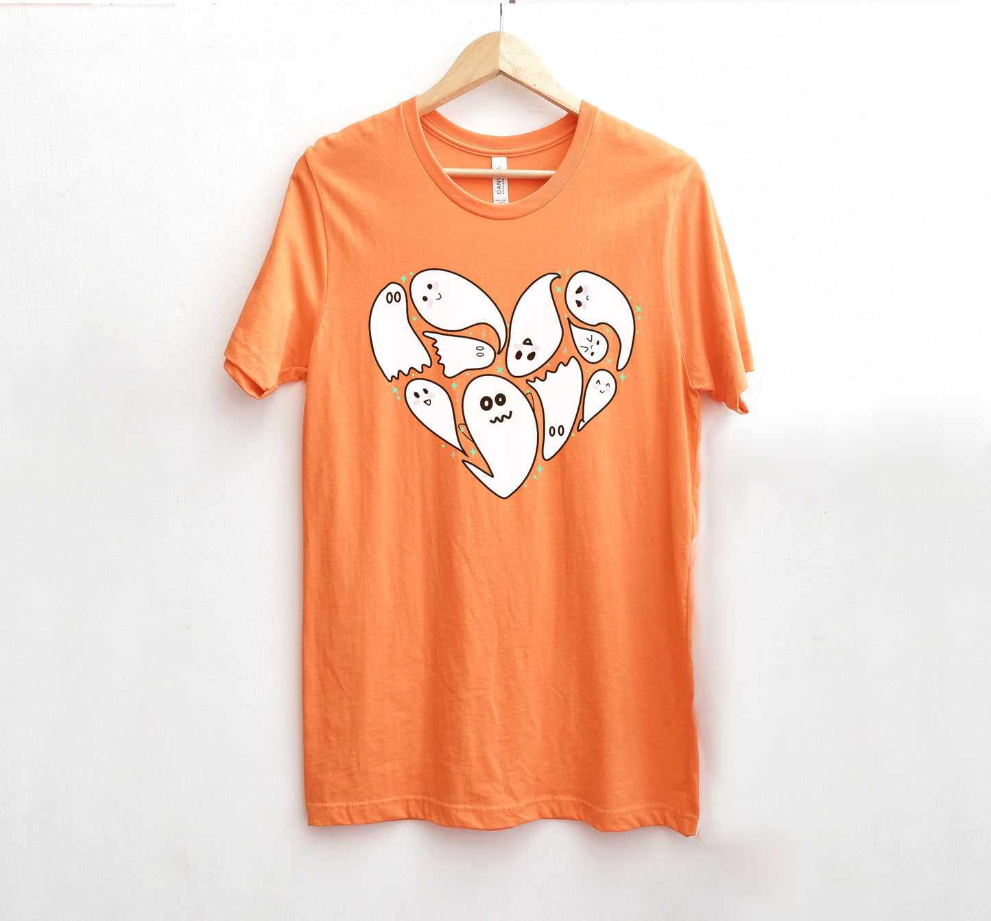 Orange t-shirt with Halloween ghost design on a white background