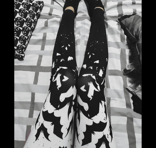 Young girl wearing a pastel goth leggings with Black and White Bats design