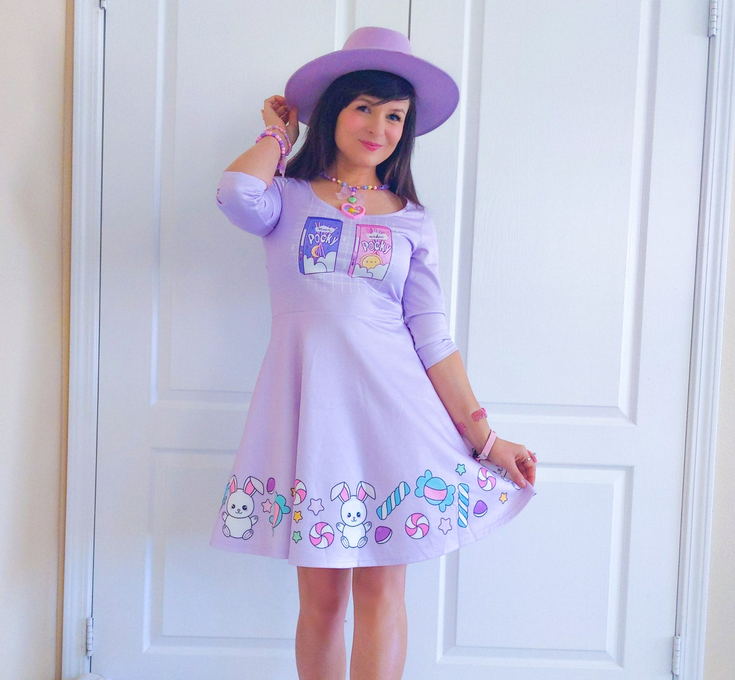 young model wearing a cute purple kawaii dress and a purple hat