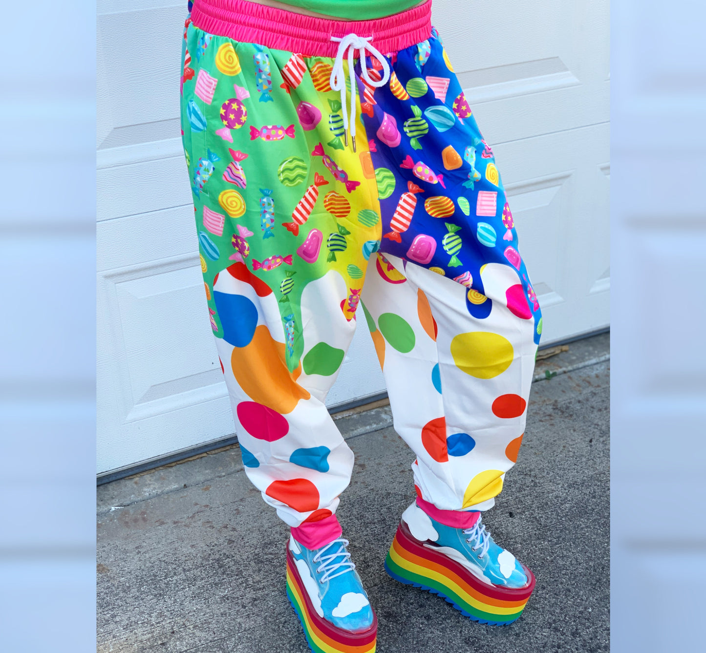 Young boy wearing Kidcore Rainbowcore Harajuku jogger pants with candy print