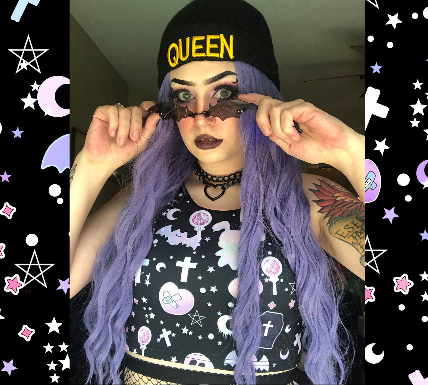 Teen girl dressed in pastel goth fashion with a spooky-cute graphic crop top