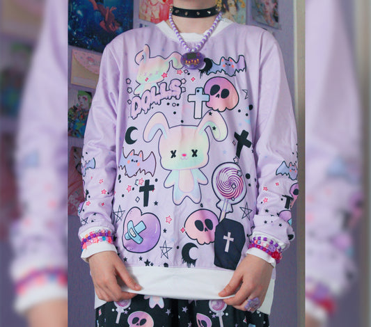 model wearing a pastel goth sweatshirt with cute creepy skull bunny design