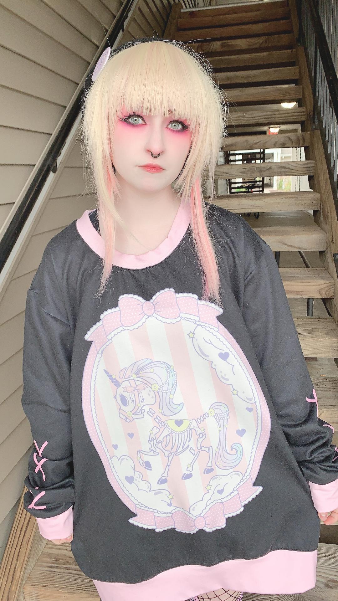 model wearing a pastel goth yami kawaii unicorn skeleton oversized sweatshirt