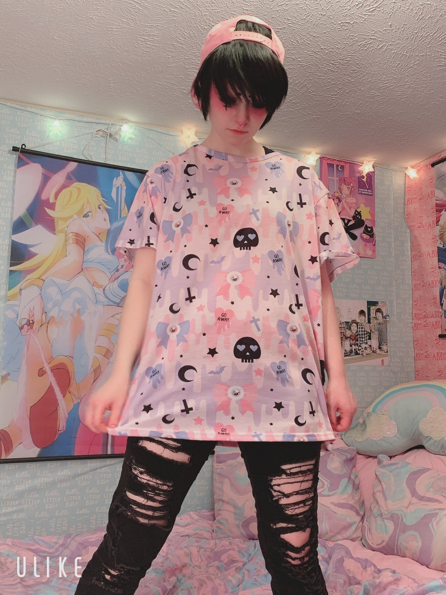 Young girl wearing a pastel goth t-shirt with soft colors and creepy cute skull design.
