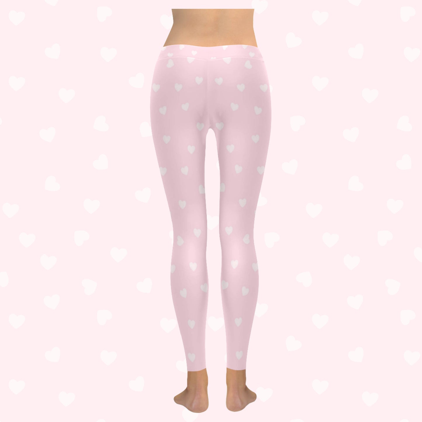 model wearing pink heart yume kawaii leggings on pink heart background