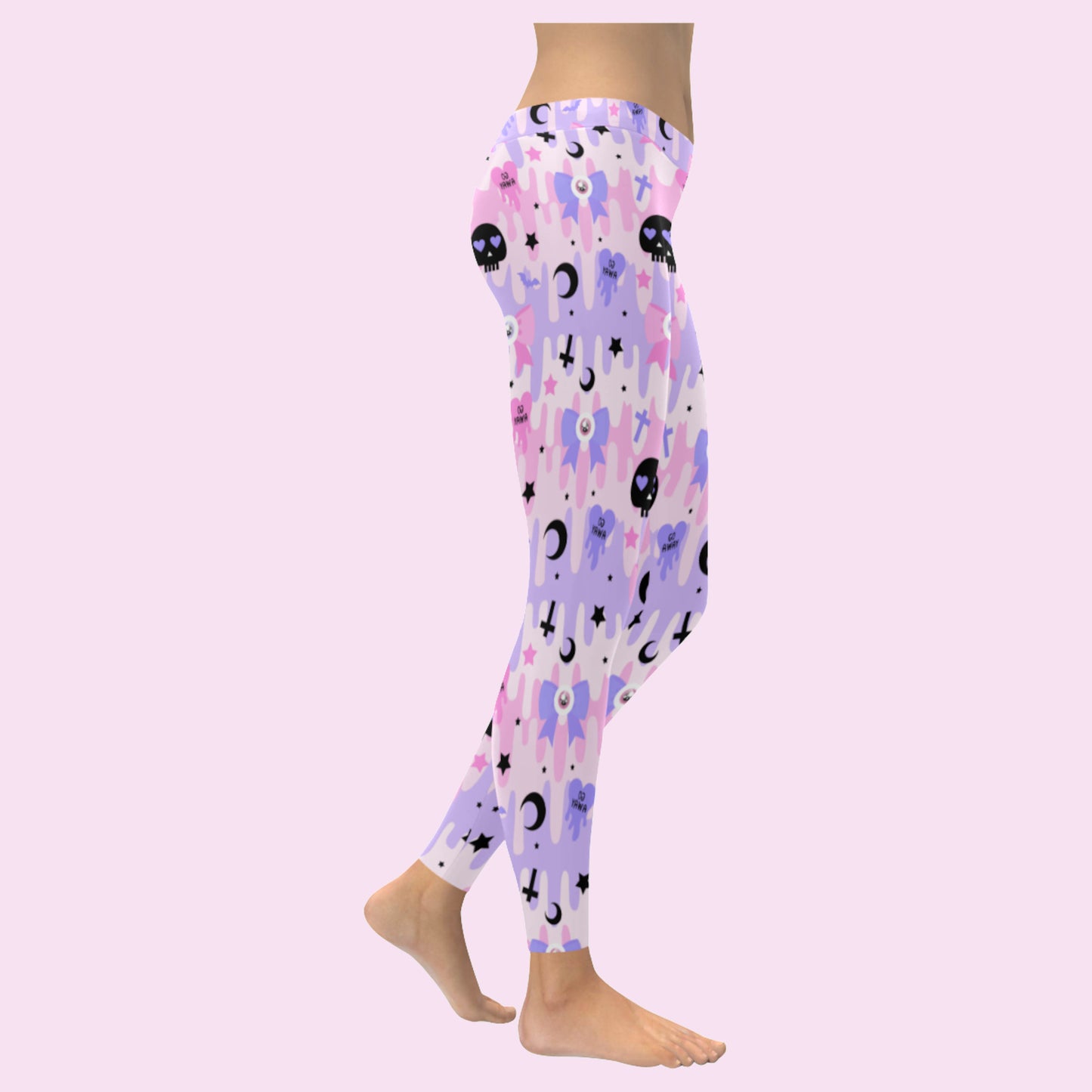 pink pastel goth skull leggings displayed on a pink background.