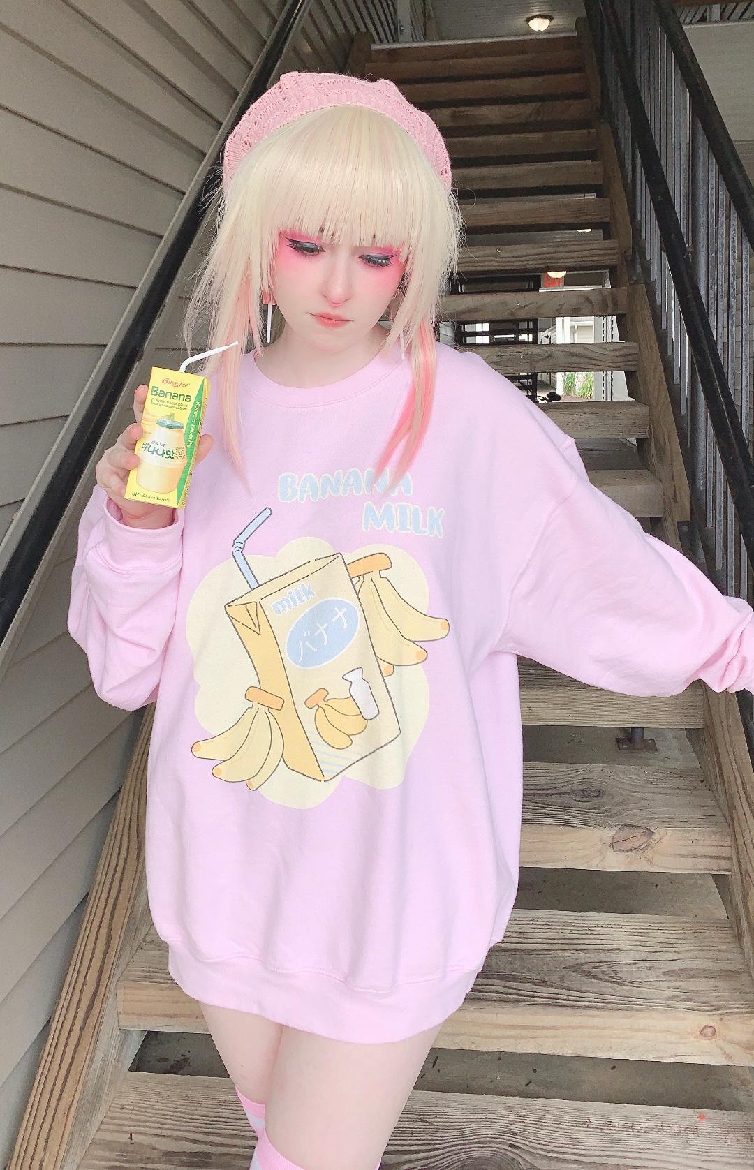 Youthful model wearing a cute kawaii sweatshirt with pastel accessories