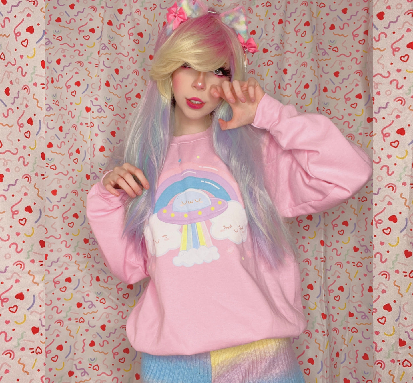 Youthful model wearing a cute kawaii sweatshirt with pastel accessories
