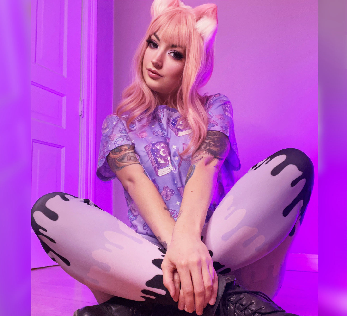 Teen girl dressed in pastel goth fashion with a spooky-cute graphic tee