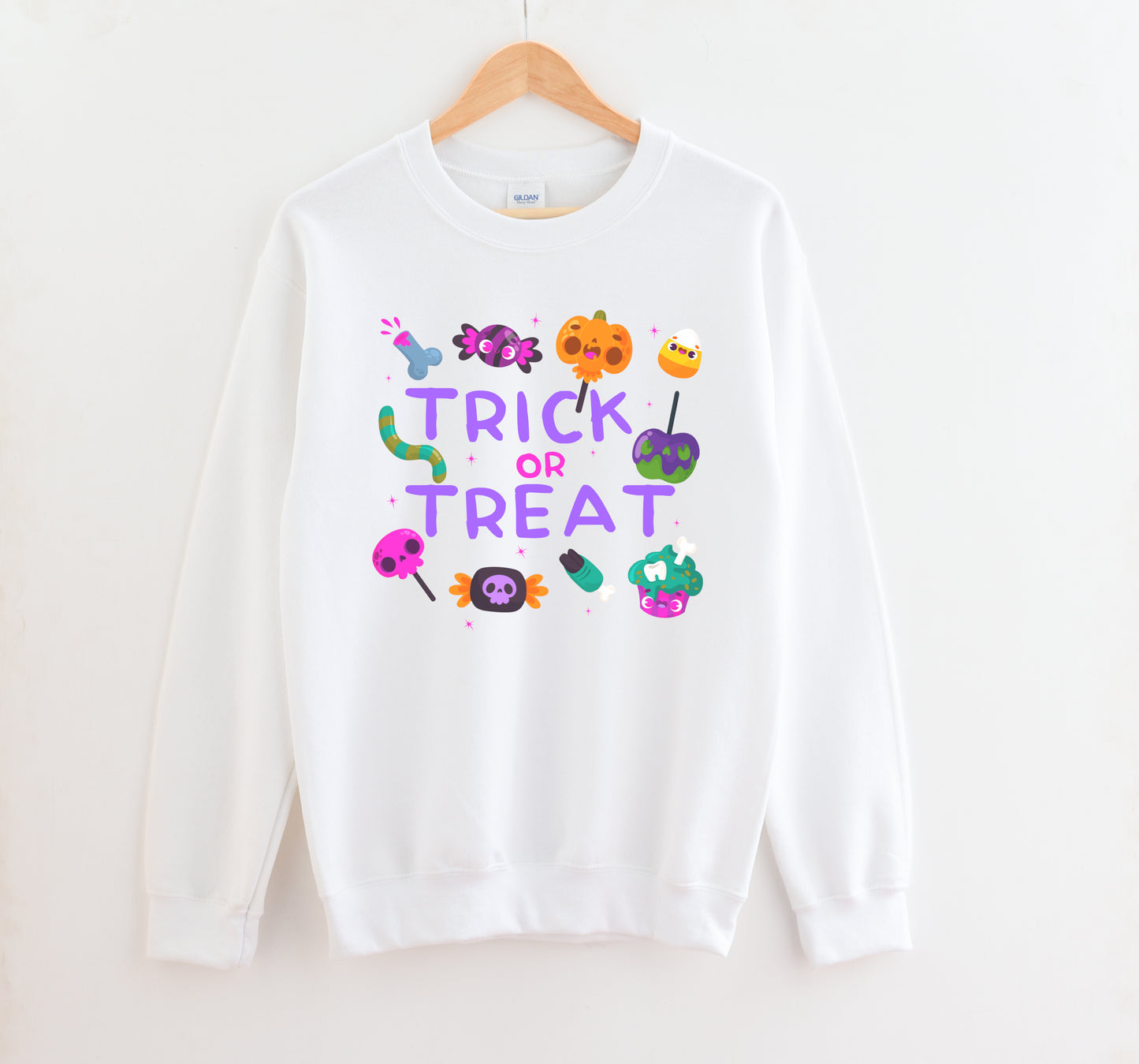 White sweatshirt with 'Trick or Treat' text and Halloween-themed graphics on a white background
