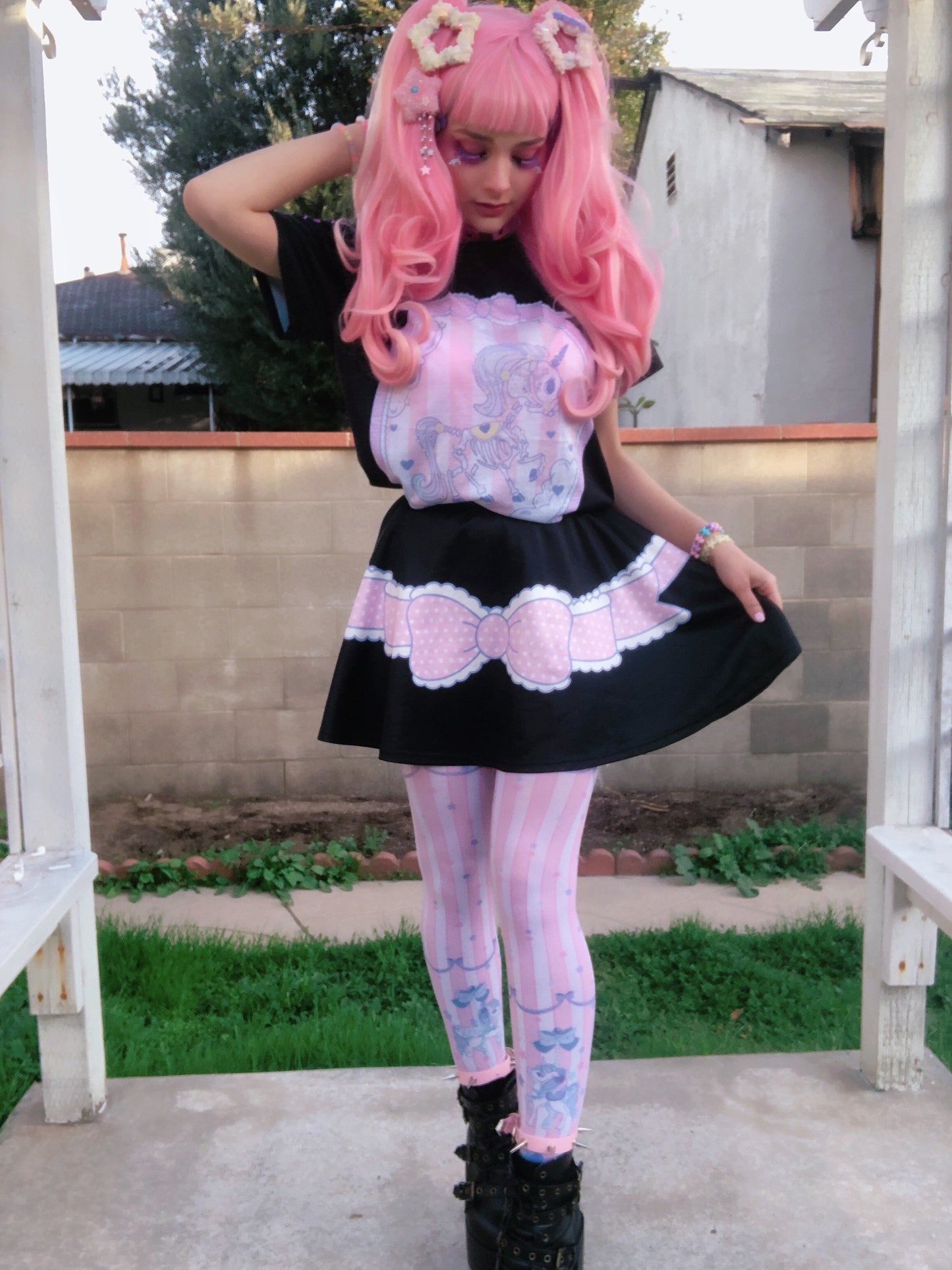 Cute girl modeling a yume kawaii black unicorn skirt featuring playful