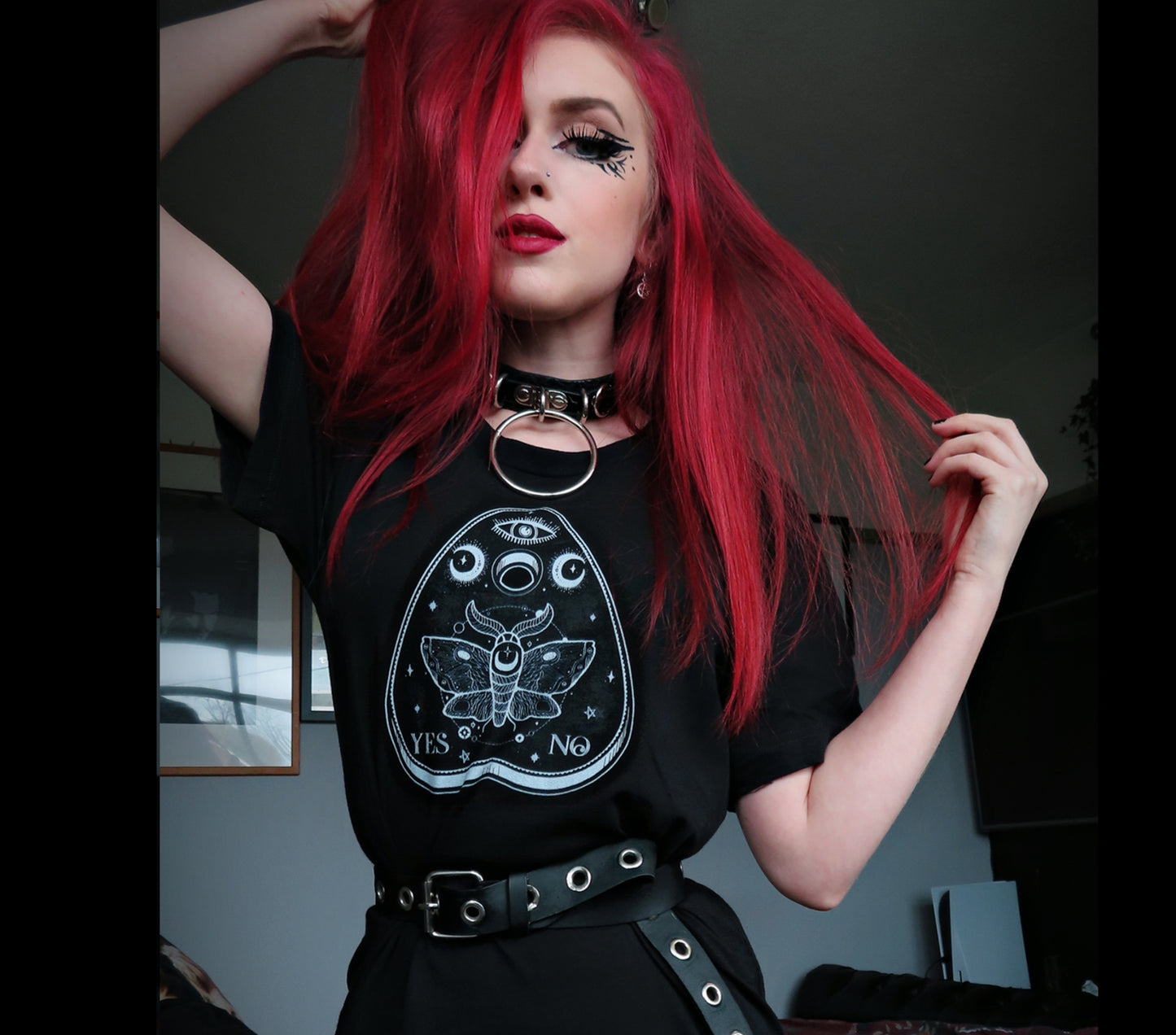 young  girl dressed in pastel goth fashion with a spooky-cute graphic t-shirt 