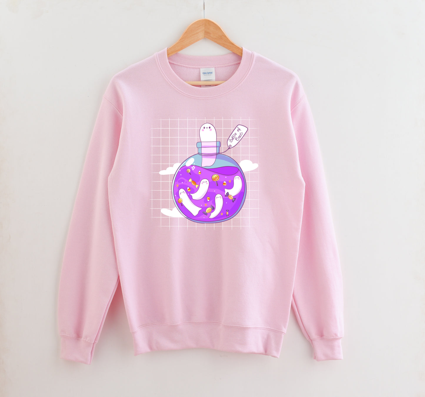 Kawaii Halloween sweatshirt with Halloween-themed graphics of a bottle of boos on a white background.
