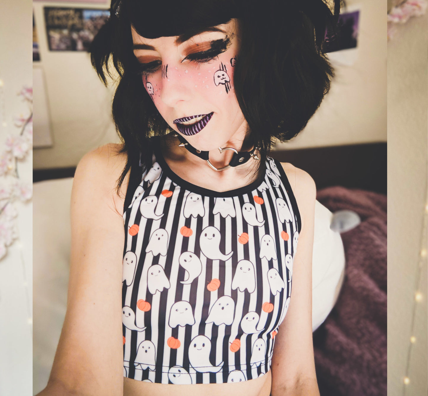 Young girl wearing a pastel goth Halloween crop top with pumpkin ghosts desing.
