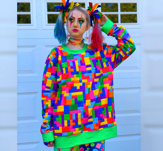 Model dressed in Decora Kei and Kidcore fashion, featuring rainbow-colored pants