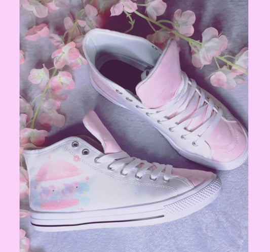 Pair of cute, stylish shoes neatly arranged on a purple background