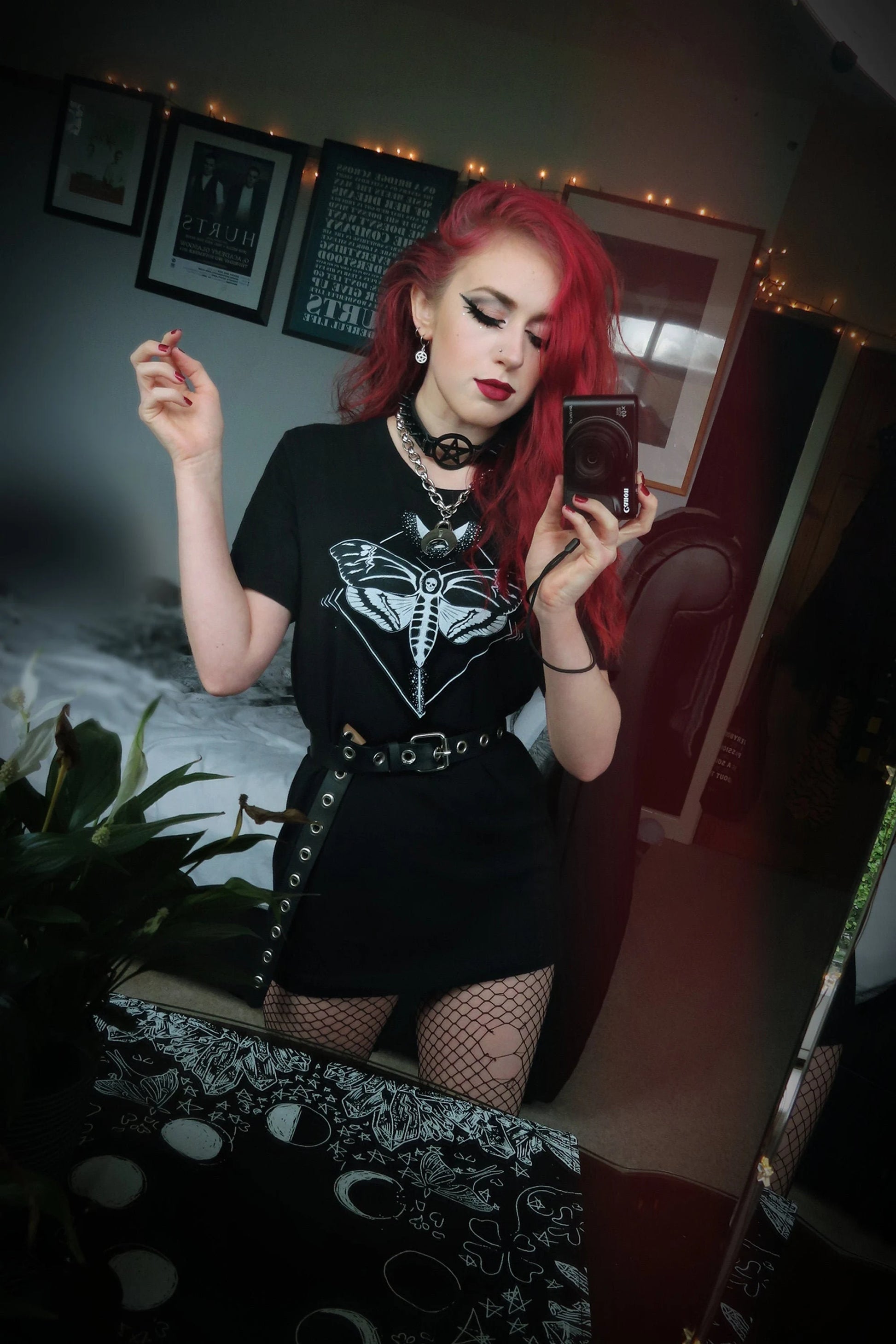 Young girl wearing a goth t-shirt with moth and moon design