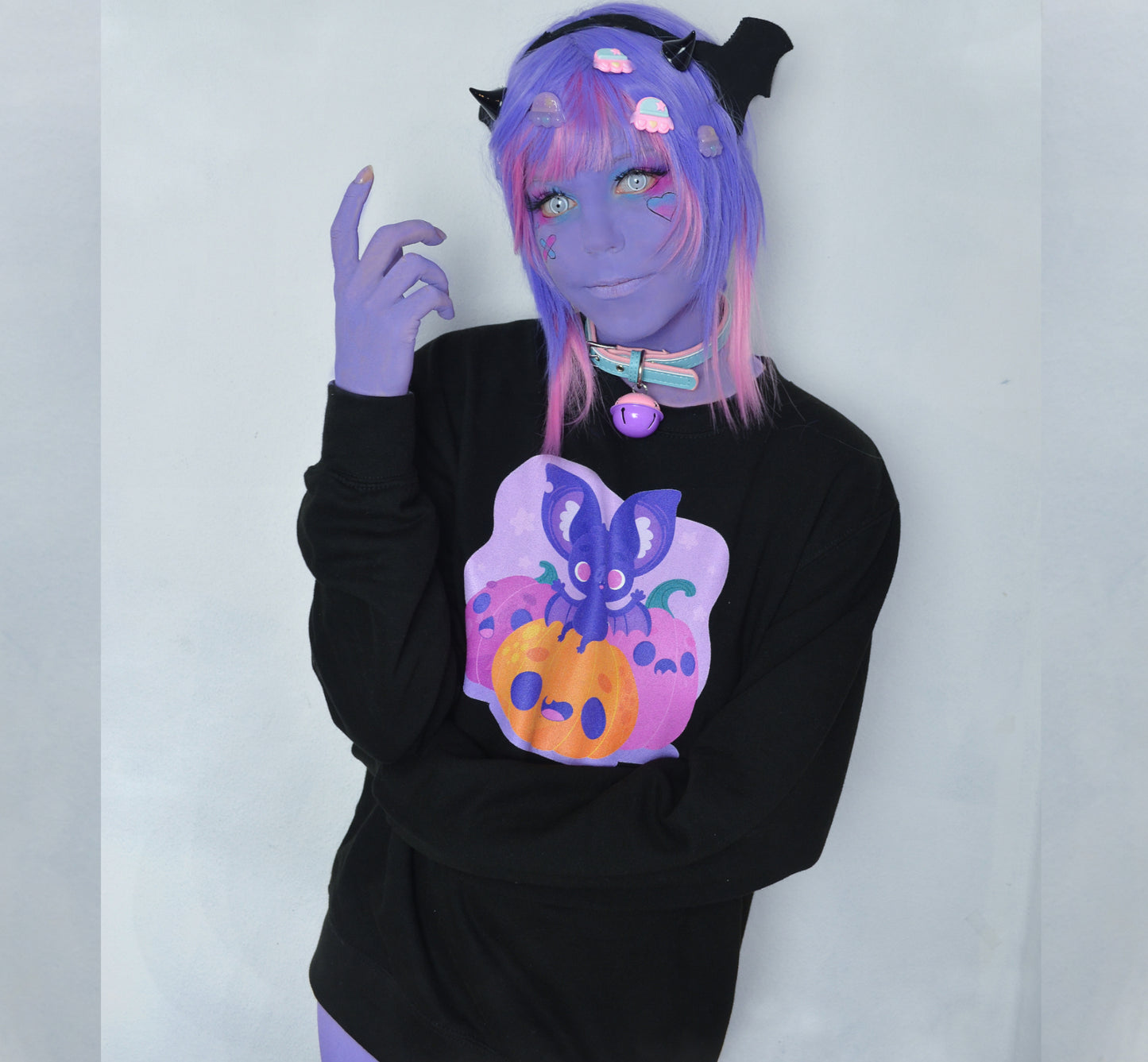 Girl modelling a Kawaii Cute Halloween sweatshirt with bat and pumpkin design