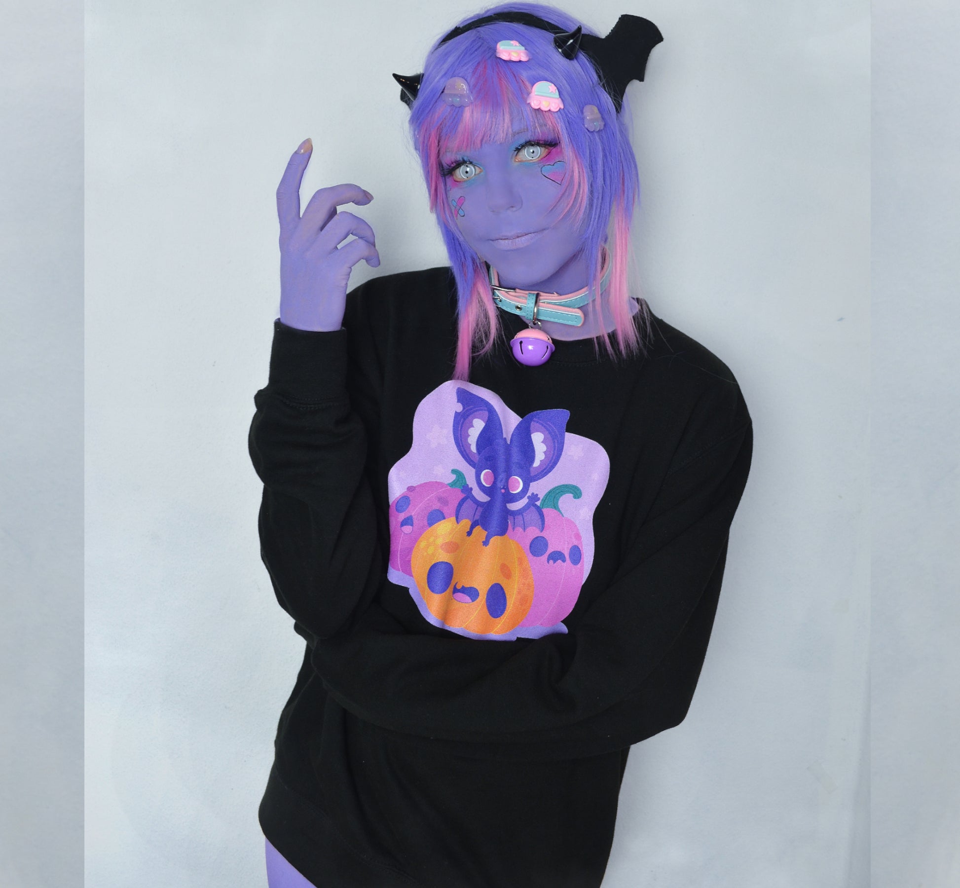 Girl modelling a Kawaii Cute Halloween sweatshirt with bat and pumpkin design