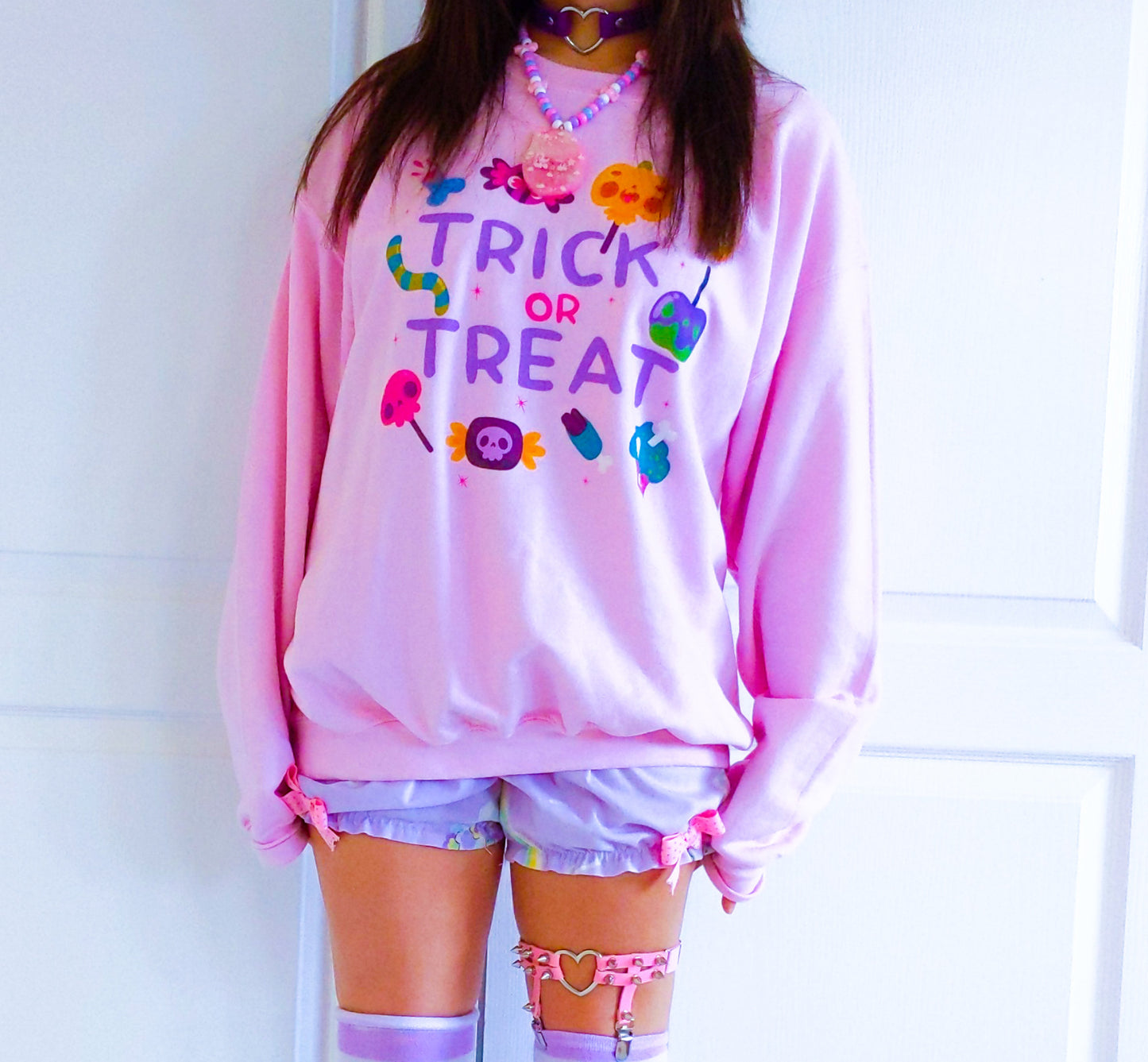Girl modelling a Kawaii Cute Halloween sweatshirt with spooky candies design